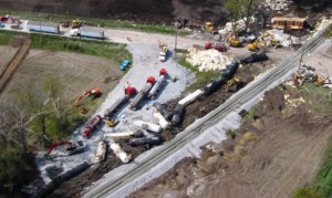 Aerial shot of 3 Harold Marcus trailers transferring product from derailed railcars.
