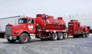 High pressure pumping truck with vacuum capabilities with hot-oiler trailer.