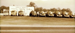 Harold standing with his truck line-up. (1960)