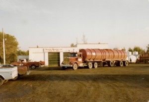 Tractor and trailer parked in front of Harold Marcus Limited. (October 1980)